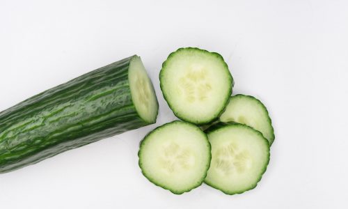 sliced cucumber on white surface